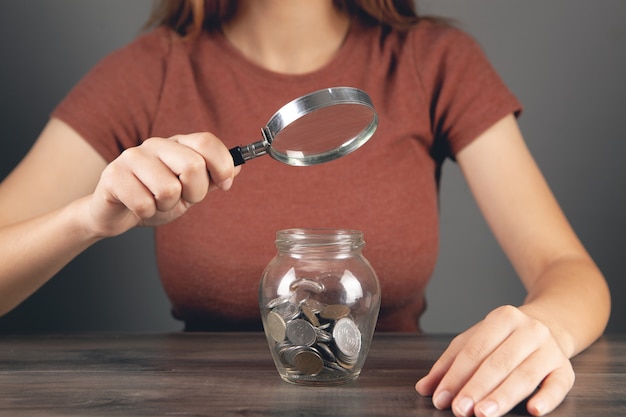 A hand holding a magnifying glass over a tax form, emphasizing the need for careful review and accuracy when claiming the Child Tax Credit.