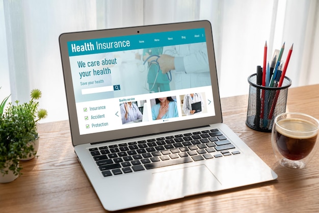 A laptop displaying the HealthCare.gov website, with various health insurance plans and subsidy options visible on the screen.