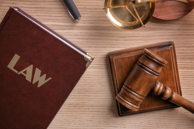 Close-up of a gavel resting on a stack of legal documents with the words 