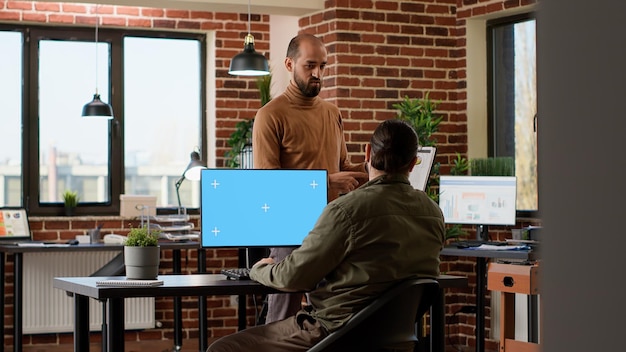 A person coding on a laptop in a modern, collaborative office space. The scene conveys adaptability and incorporating technology into the workplace.
