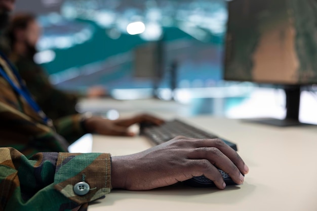 A close-up shot of a veteran's hands typing on a laptop, with the screen displaying a college application form. A pen and notebook are nearby, symbolizing the planning and preparation involved in pursuing education benefits.