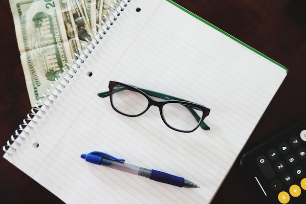 A close-up of a U.S. tax form with a highlighted section indicating the area for claiming the Earned Income Tax Credit. The form is on a desk with a pen and a pair of glasses.